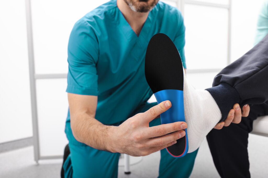 Doctor holding orthotic
